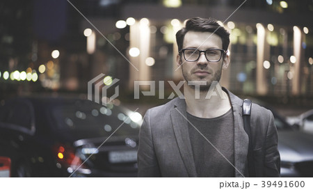 A closeup of a bearded man on the street at night A closeup of a bearded man on the street at night 39491600