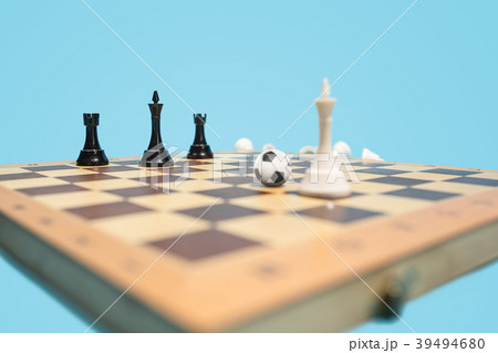 soccer ball of chess pieces on the board 39494680