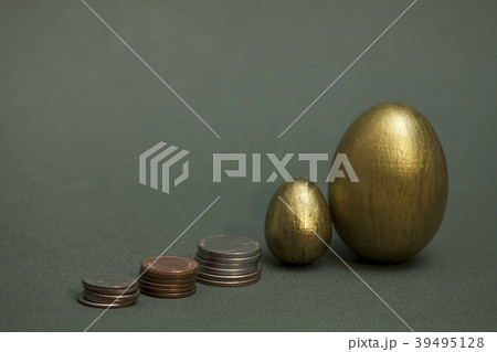 coins pile up and golden eggs 39495128