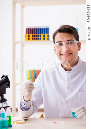 Young chemist student working in lab on chemicals 39496458