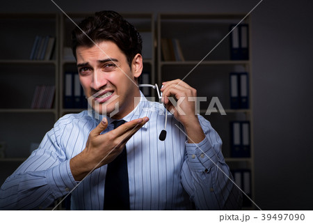 Tired and exhausted helpdesk operator during night 39497090