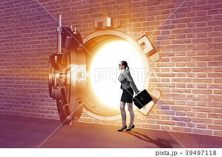 Businessman in front of banking vault door Businessman in front of banking vault door 39497118
