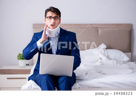 Businessman with neck injury working from home 39498323