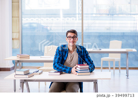 Student studying in the empty library with book Student studying in the empty library with book 39499713