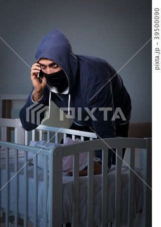 Criminal stealing baby in human child traficking 39500090