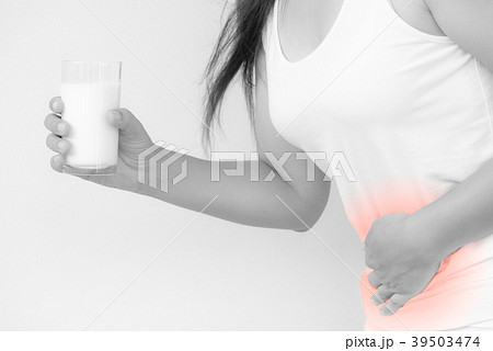 Woman hand holding glass of milk and stomach ache Woman hand holding glass of milk and stomach ache 39503474
