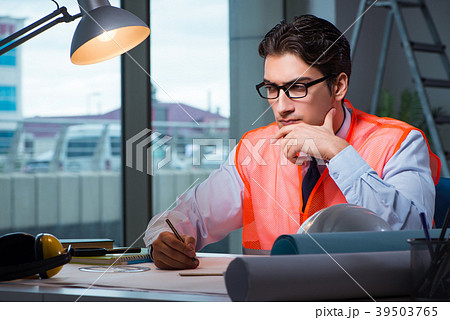 Construction architect working on drawings late at Construction architect working on drawings late at 39503765
