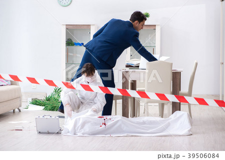 Forensics investigator at the scene of office 39506084