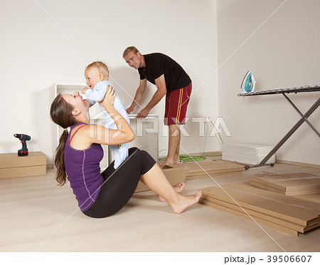 Young Family with a Baby Moving to New Apartment 39506607