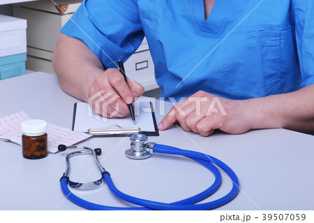 Close-up view of female doctor's hands filling Close-up view of female doctor's hands filling 39507059