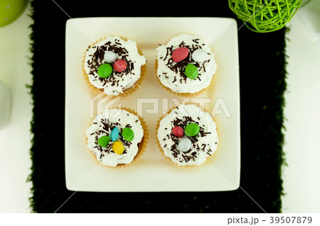 Cupcakes with colored on a white plate 39507879