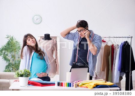Pregnant woman visiting tailor for new clothing 39508380
