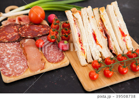 Club sandwiches next to cherry tomatoes, radish Club sandwiches next to cherry tomatoes, radish 39508738