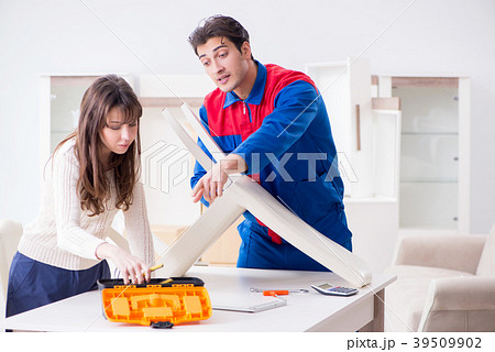 Contractor repairman assembling furniture under 39509902