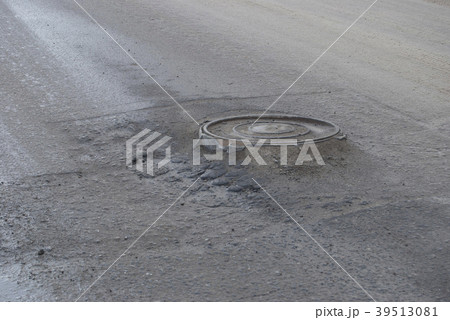 Drainage well in the center of the roadway.  39513081