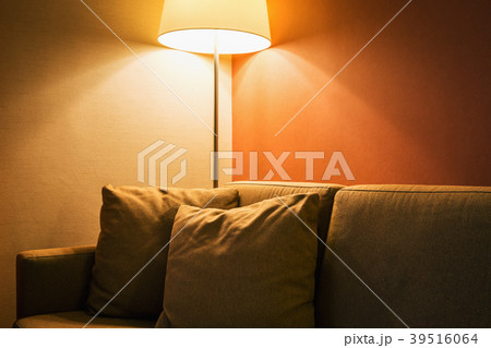 floor lamp next to the sofa in the room or hotel 39516064