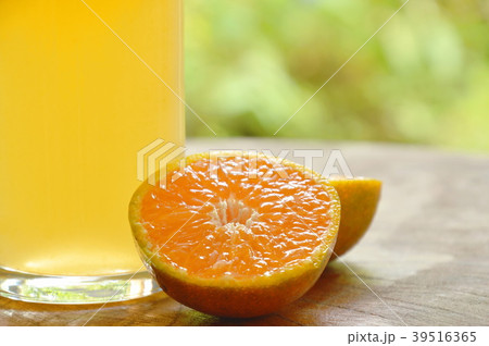 orange juice in glass and tangerine cutting orange juice in glass and tangerine cutting 39516365