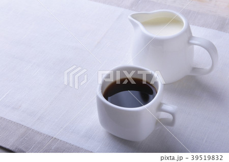 Cup of hot coffee espresso, coffee beans, jug of 39519832