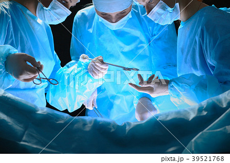 Group of surgeons at work in operating theater Group of surgeons at work in operating theater 39521768