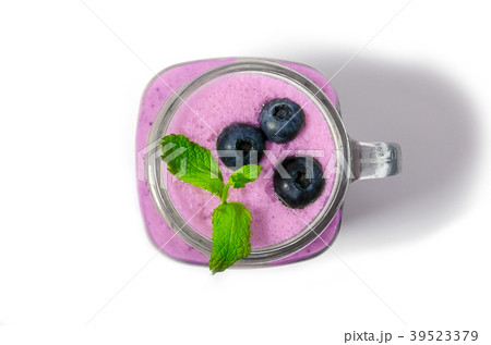 Blueberry smoothie with mint in mason jar glass Blueberry smoothie with mint in mason jar glass 39523379