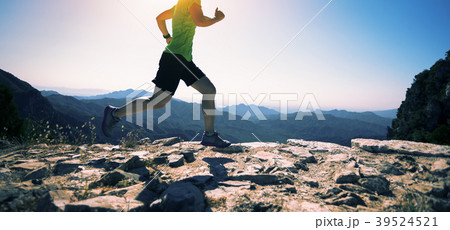sporty  woman runner running on mountain top 39524521