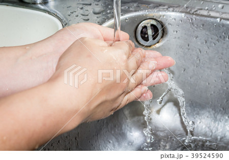 Woman washing hand under running 39524590