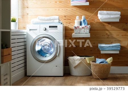 Interior of real laundry room with  washing machine at window at 39529773