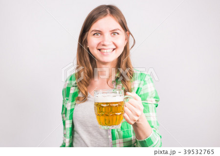 Cheerful young woman holding a beer mug full of Cheerful young woman holding a beer mug full of 39532765
