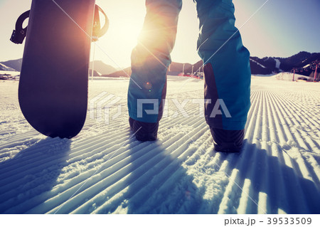 snowboarder with snowboard stand on ski piste snowboarder with snowboard stand on ski piste 39533509