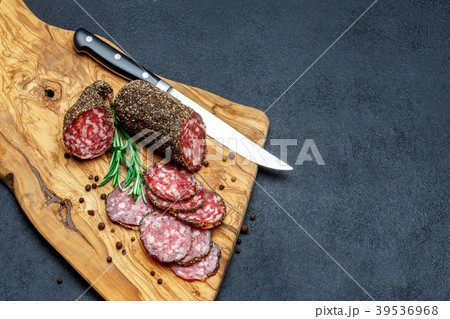Dried organic salami sausage on wooden cutting 39536968