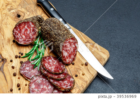 Dried organic salami sausage on wooden cutting Dried organic salami sausage on wooden cutting 39536969
