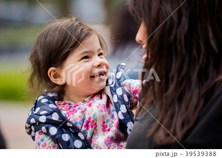 A little daughter in her mother's arms. A little daughter in her mother's arms. 39539388