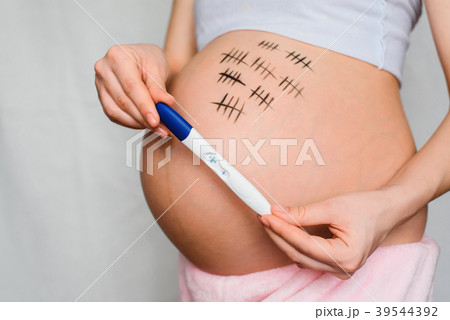 pregnant girl holding pregnancy test with positive 39544392