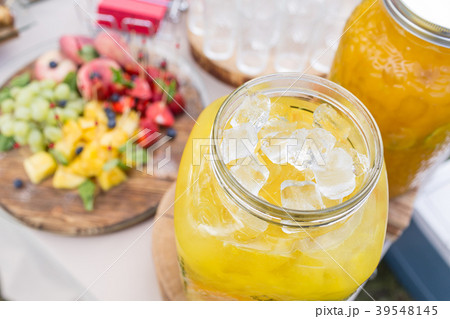 Glass bank of lemonade with sliced citrus fruits Glass bank of lemonade with sliced citrus fruits 39548145