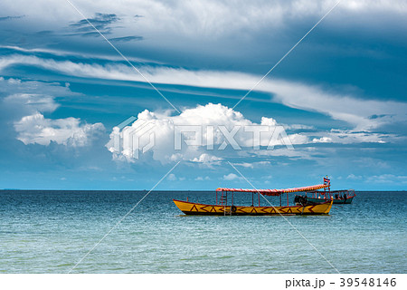 Yellow Longtail boat moored close to the beach  39548146