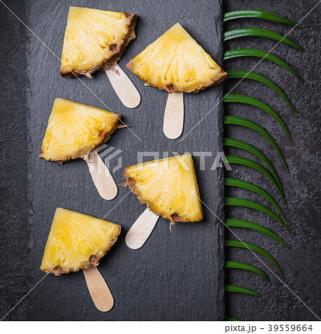 Ripe Pineapple slices on a black background 39559664