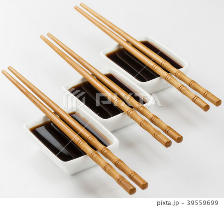 Three bowls of soy sauce on white background 39559699