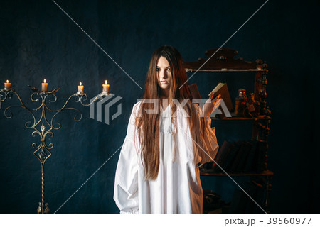 Witch holds spellbook in hands, dark magic 39560977