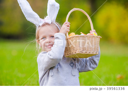 Portrait of little girl with a basket full of 39561336