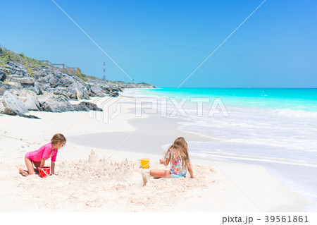 Adorable little kids play with sand on the white Adorable little kids play with sand on the white 39561861
