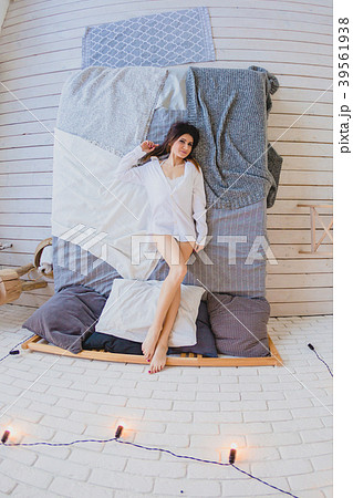 Sexy slender brunette lying on a big bed 39561938