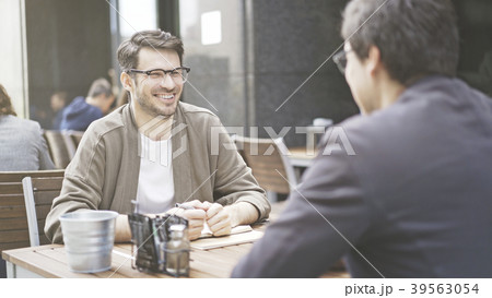Two friends are laughing at table of the cafe Two friends are laughing at table of the cafe 39563054