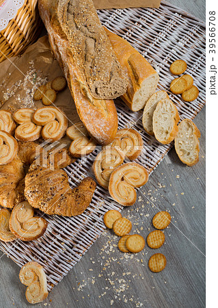 Various kinds of bread and bakery products on table 39566708