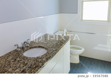 New modern bathroom with tiles and brown cabinet. New modern bathroom with tiles and brown cabinet. 39567086