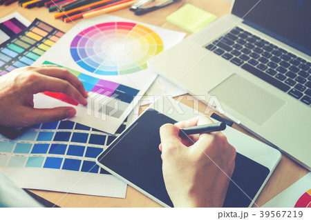 Graphic designer drawing on graphics tablet Graphic designer drawing on graphics tablet 39567219