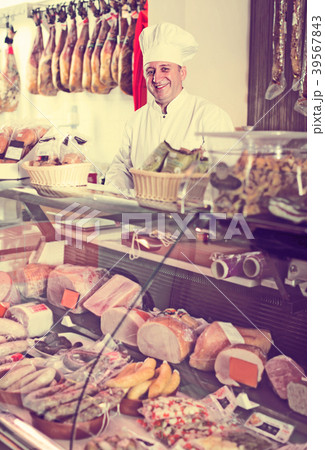 butcher with wurst at counter butcher with wurst at counter 39567843