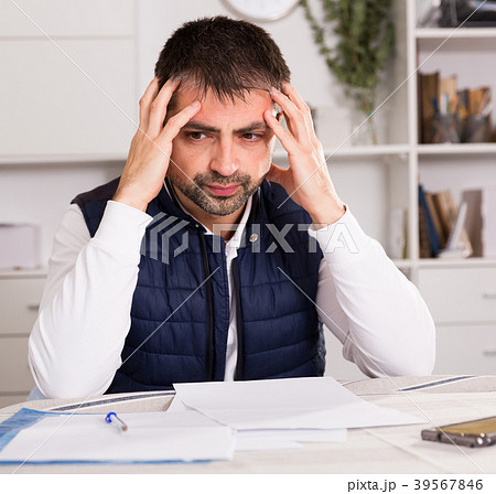 Distressed male having problems with paying utility bills 39567846