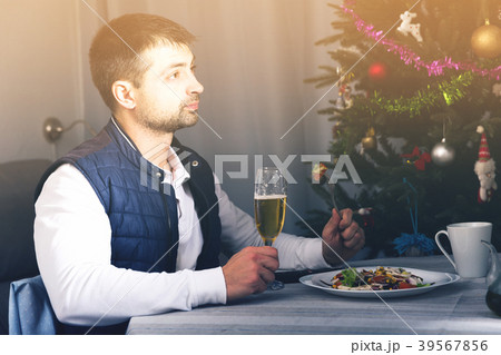Young man celebrating New Year, having dinner, watching tv 39567856