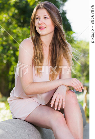 Young female is sitting and having a rest on the bench 39567976