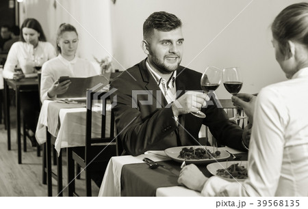 Elegant female and her boyfriend are celebrating date for dinner Elegant female and her boyfriend are celebrating date for dinner 39568135